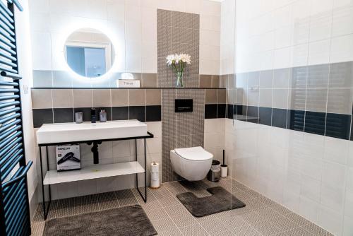 a bathroom with a sink and a toilet at Apartmány Marienhof in Znojmo