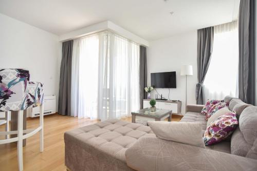 a living room with a couch and a television at Apartman Drobnjak Center-sea View in Budva