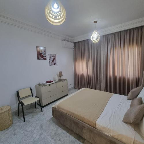 a bedroom with a bed and a desk and a chair at Tunis medina in Tunis