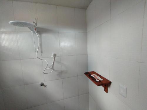 a bathroom with a shower with a wooden shelf at Casa de Sal Ocean - Cajueiro da Praia (Vista Mar) in Cajueiro
