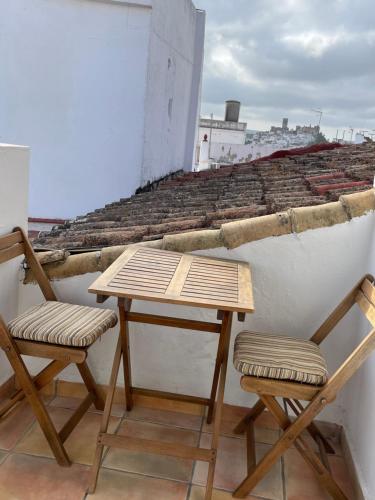 a table and two chairs sitting on a roof at Esencia de Arcos in Arcos de la Frontera