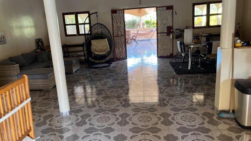 a living room with a couch and a tile floor at Casa Contente Bake in Abene