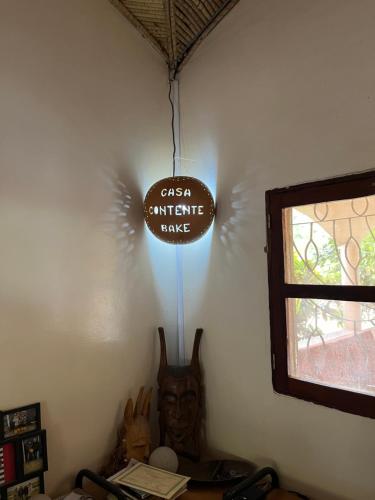 a sign that says cason earthquake dance hanging in a room at Casa Contente Bake in Abene