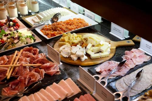 a buffet of different types of food on a table at Best Western Premier Hotel Dante in Barcelona