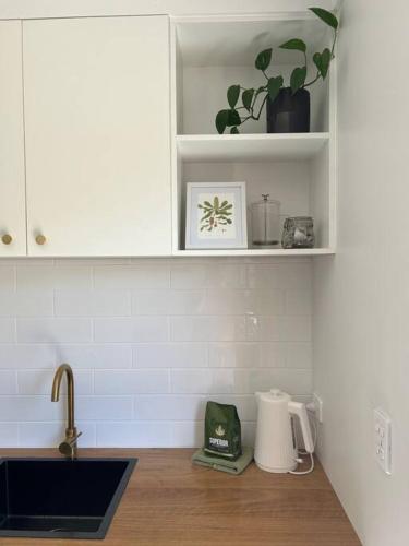 a kitchen with a sink and a counter top at Little Banksia in Sawtell