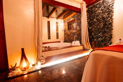 Una cama o camas en una habitación de Pousada Chale Luiz
