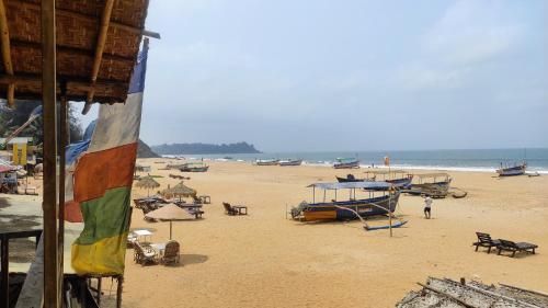 a beach with chairs and umbrellas and the ocean at Mia's beach resort goa in Patnem