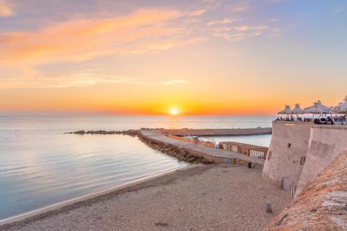 a sunset over the ocean with a pier at Sabhé Gallipoli in Gallipoli