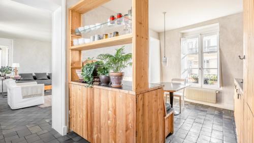 une cuisine et un salon avec un meuble en bois dans l'établissement Famous parisian designer's pied-à-terre in Le Marais, à Paris