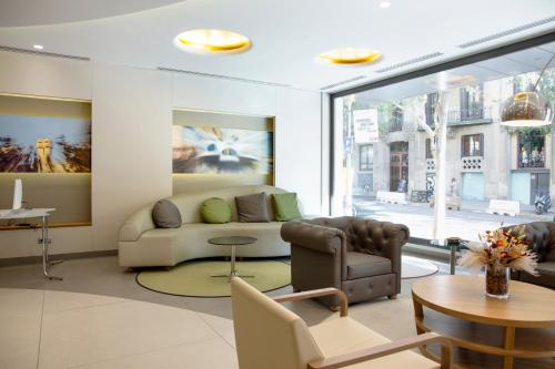 a living room with a couch and a table at Best Western Premier Hotel Dante in Barcelona