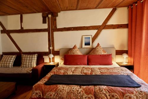 a bedroom with a large bed with red pillows at Inselgasse in Konstanz