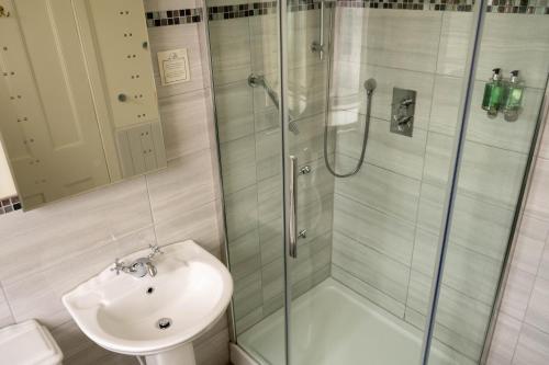 a bathroom with a shower and a sink at Western Isles Hotel in Tobermory