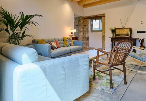 a living room with a couch and a chair at Hotel Molí Cardedeu in Cardedeu