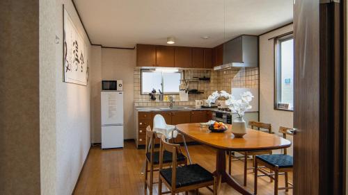 a kitchen and dining room with a table and chairs at 福助白露double bath Spacious Japanese house Nipponbashi Dotonbori Namba Nara Direct in Osaka