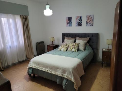 a bedroom with a bed and two night stands at Las Violetas in Lobos