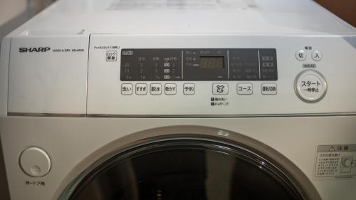 a white washing machine with a white hood at 福助白露double bath Spacious Japanese house Nipponbashi Dotonbori Namba Nara Direct in Osaka
