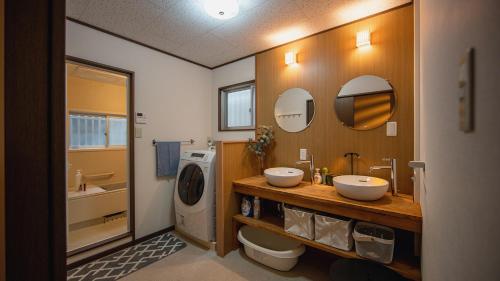 a bathroom with two sinks and a washing machine at 福助白露double bath Spacious Japanese house Nipponbashi Dotonbori Namba Nara Direct in Osaka