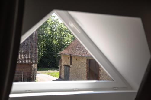 a view of a building through a window at La Marbecque in Samer
