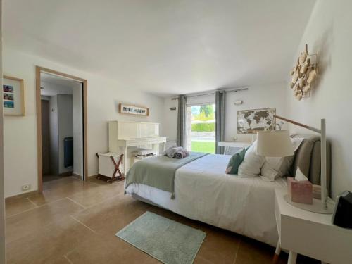 une chambre avec un lit, un bureau et une fenêtre dans l'établissement Capleouna-Manou, à Antibes