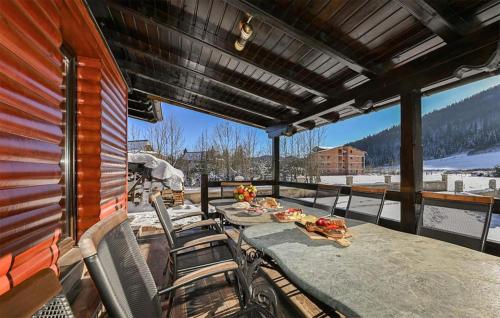 a patio with a table and chairs on a balcony at 5 Bedroom Amazing Home In Jasenak in Jasenak