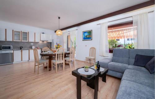 a living room with a couch and a table and a kitchen at Nice Apartment In Valbandon With Wifi in Valbandon
