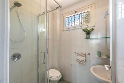 a bathroom with a shower and a toilet and a sink at Villino Alice a Mondello by Wonderful Italy in Palermo