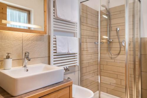 a bathroom with a sink and a shower at Apartment Sassun in Laion