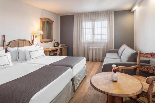 a hotel room with a bed and a couch at Melia Sierra Nevada in Sierra Nevada