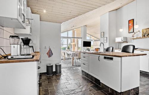 a kitchen with white cabinets and a counter at 4 Bedroom Lovely Home In Faaborg in Fåborg