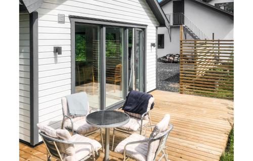a patio with a table and chairs on a deck at Awesome Home In Jonstorp With Wifi in Jonstorp