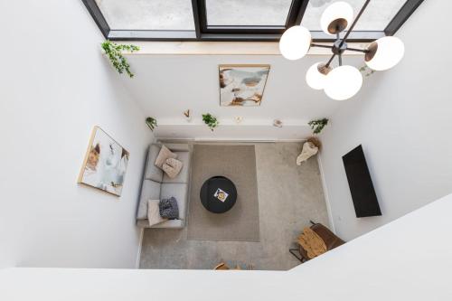 an overhead view of a living room with a chandelier at Le Mile End by M11 - 2 BDR Loft with Sofa Bed in Montréal