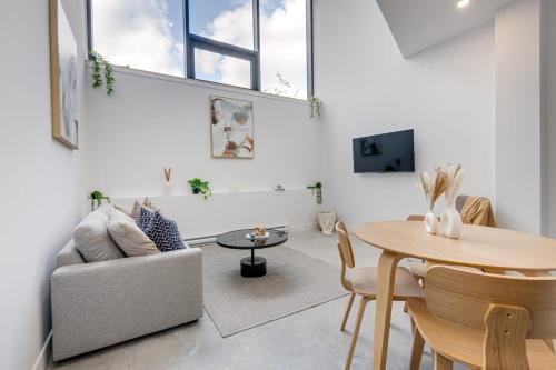a living room with a couch and a table at Le Mile End by M11 - 2 BDR Loft with Sofa Bed in Montréal