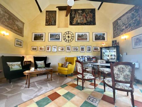 a room with a table and chairs and pictures on the wall at Sans Souci Bed and Breakfast Luxe Heated Pool and Restaurant in Luzillé