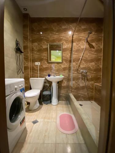 a bathroom with a shower and a sink and a toilet at Siqvaruli in Tbilisi City