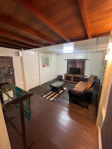 a living room with a couch and a table at Nami Homestay Teluk Batik in Lumut