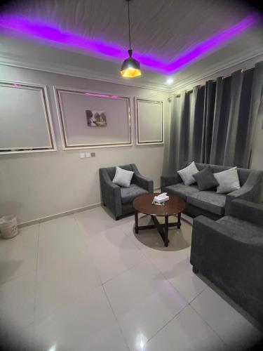 a living room with purple lights on the ceiling at Afaq Al Raha in Khamis Mushayt