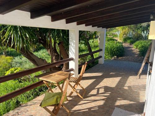 a wooden chair sitting on the porch of a house at Moinhos do Paneiro in Santiago do Cacém