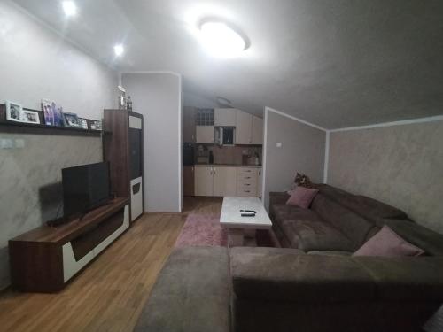 a living room with a couch and a tv at Apartment 44 in Podgorica
