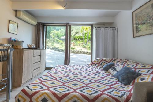 a bedroom with a bed and a large window at Studio - les Adrets Esterel in Fréjus