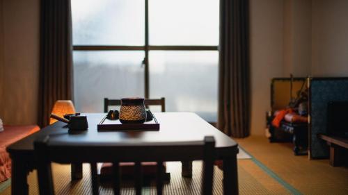 a living room with a coffee table and a room with a window at 福助白露double bath Spacious Japanese house Nipponbashi Dotonbori Namba Nara Direct in Osaka