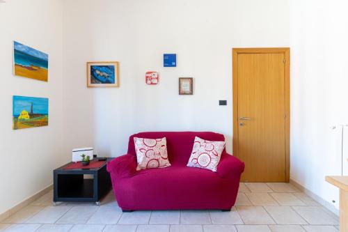 a living room with a red couch and a table at I Mori Cà in Modica