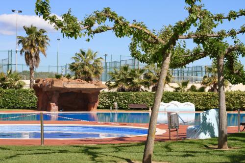 a swimming pool in a resort with a water slide at Alea Rentals - Los Juncos in La Pineda