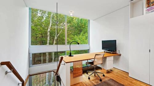 a home office with a desk and a window at Villa Spectrum Luxury Villa with Pool & Outdoor Shower in East Hampton in Springs