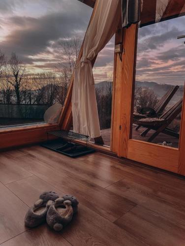 a snake on the floor of a room with a window at Lovely Chalet in Tuzla