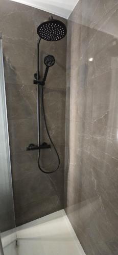 a shower with a shower head in a bathroom at Hotel Alicante Lisboa in Lisbon