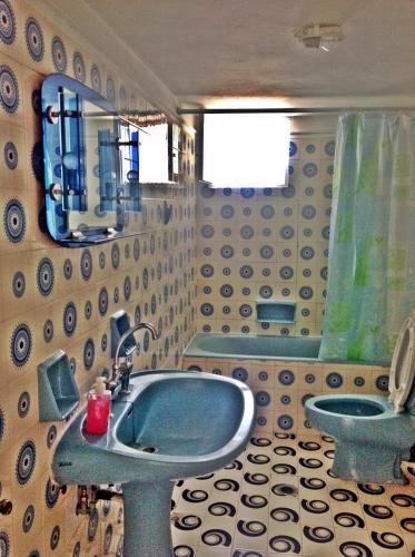 a bathroom with a blue sink and a toilet at Papanikola House 2 in Astypalaia