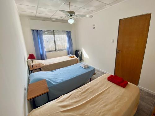 a hospital room with two beds and a ceiling fan at Alquiler Temporario Las Parejas in Las Parejas