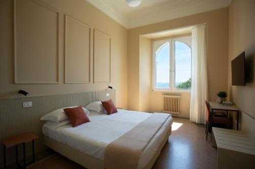 a bedroom with a large bed and a window at Hotel San Marco Sestola in Sestola