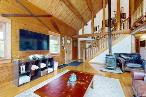 a living room with a fireplace and a large tv at Charming Hideaway in Scarborough