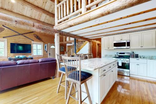 a kitchen and living room in a log cabin at Charming Hideaway in Scarborough